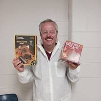 Ted holding history and archaeology learning kits